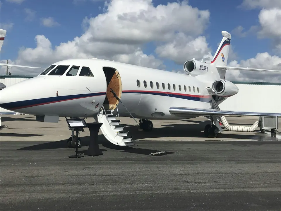 Private aircraft parked on an apron with boarding steps at the open door
